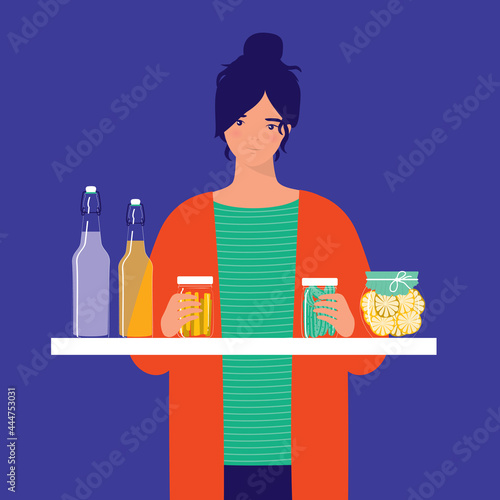 Young Smiling Woman Holding A Jar Of Fermented Ginger And Pickles. Fermented Foods And Drinks. Healthy Probiotic Food. Fermented Grape Juice, Kombucha Tea, And Fermented Lemon On Table.