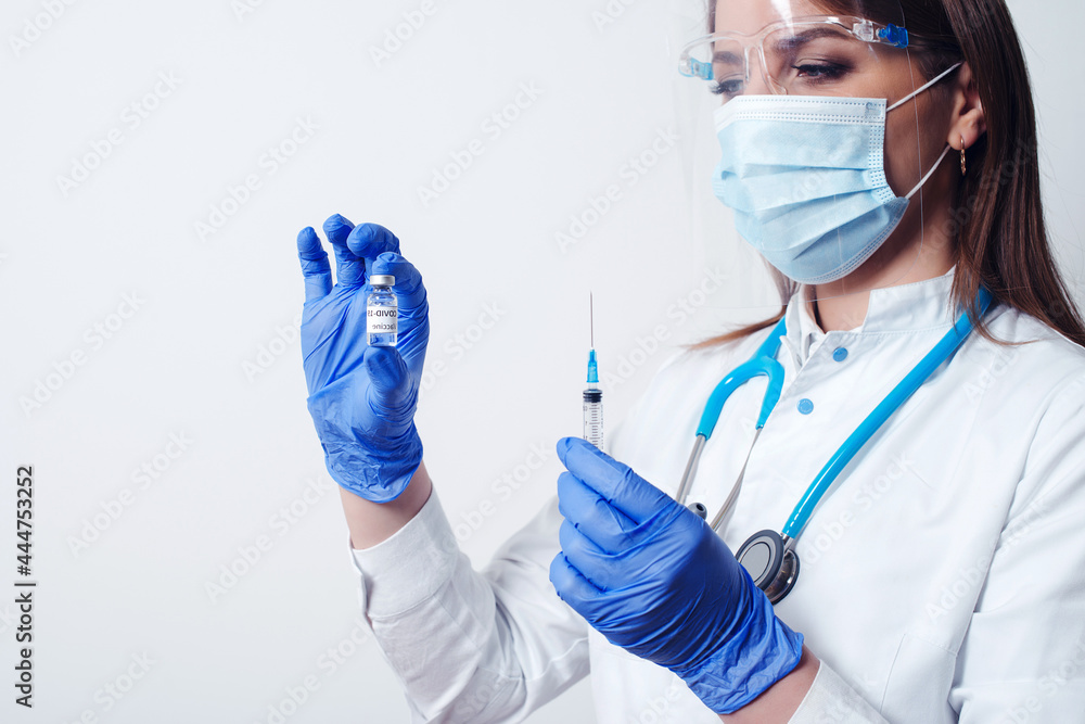 Doctor holding Coronavirus vaccine bottle and syringe injection medicine. Vaccine Concept of fight against coronavirus. Doctor holding Coronavirus vaccine bottle and syringe injection medicine. Vaccine Concept of fight against coronavirus.