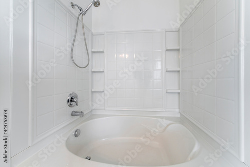 Foto Bathtub and shower combo with wall mounted handheld shower and faucet
