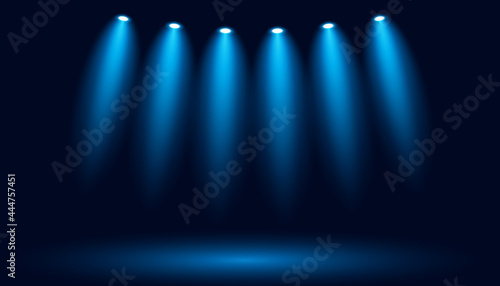 Glowing spotlights on a dark blue background. Vector backdrop illustration.