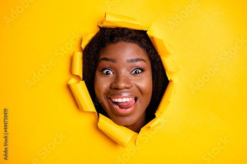 Photo of crazy adorable funky lady stick out tongue look camera through yellow vibrant color background © deagreez