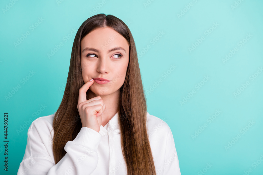 Portrait of attractive curious long-haired girl overthinking copy space isolated over bright teal turquoise color background Portrait of attractive curious long-haired girl overthinking copy space isolated over bright teal turquoise color background