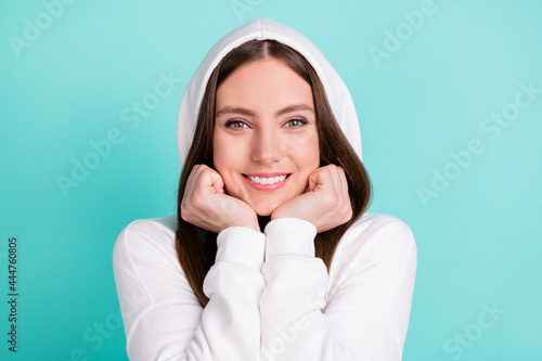 Photo of sweet adorable young lady wear white sweatshirt smiling arms cheeks isolated turquioise color background photo