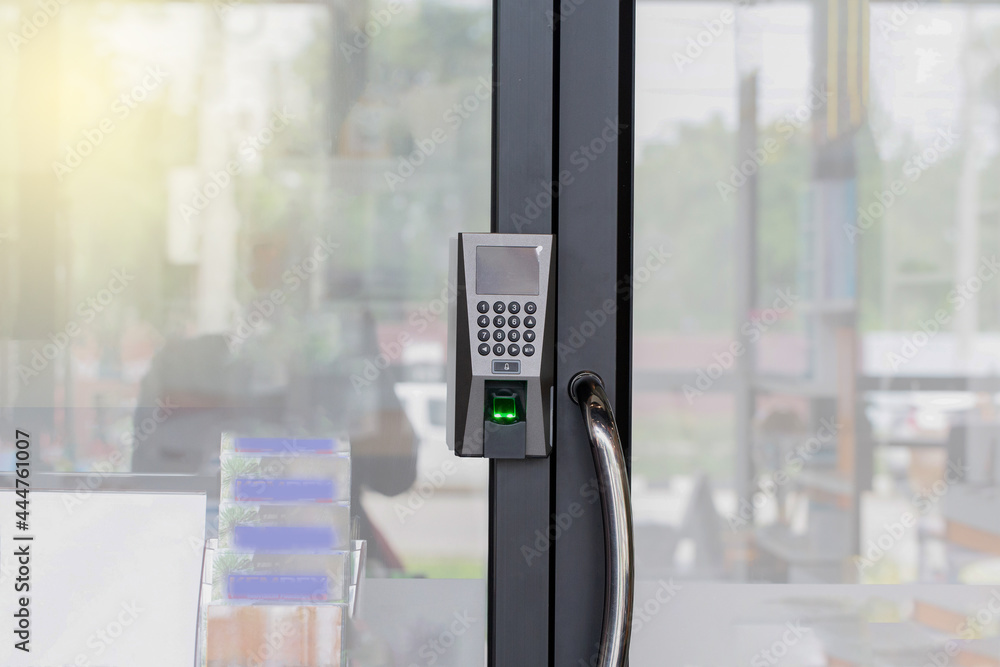 Fingerprint scanner on glass door for unlock door security system. The