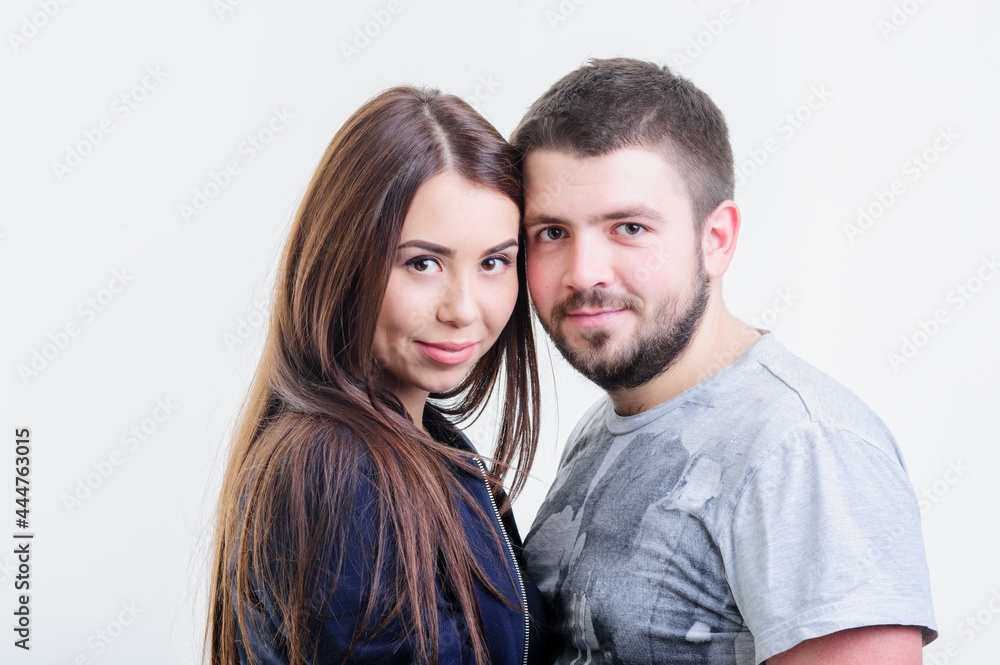 Attractive yang couple stand in a loving embrace looking with expressions Attractive yang couple stand in a loving embrace looking with expressions