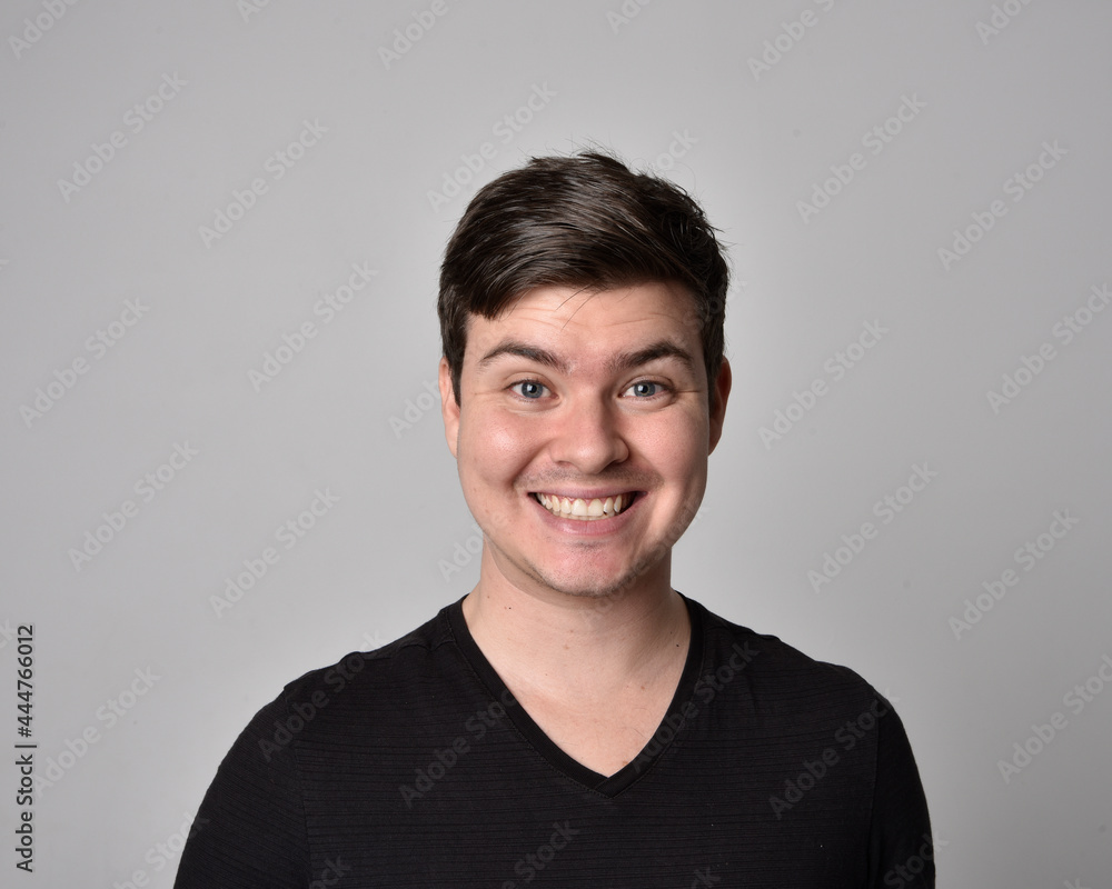 Close up head and shoulders portrait of a brunette. young man with a variety of expressive facial expressions. Isolated on a light grey studio background. Close up head and shoulders portrait of a brunette. young man with a variety of expressive facial expressions. Isolated on a light grey studio background.