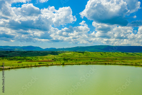 A lake against the background of mountains and the sky.