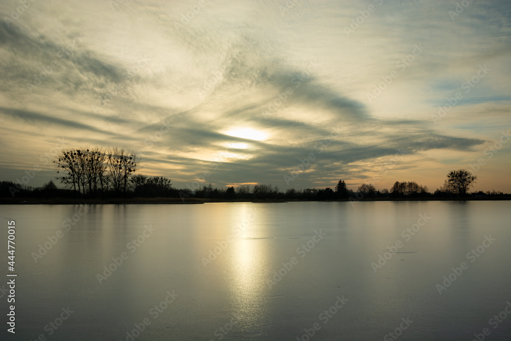 A frozen lake and sunshine on the ice sheet