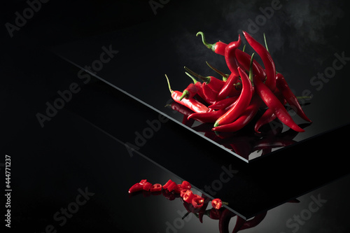 Red hot chili pepper on a black background.