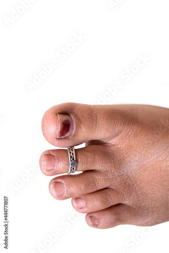 Indian women feet with silver ornament on white background