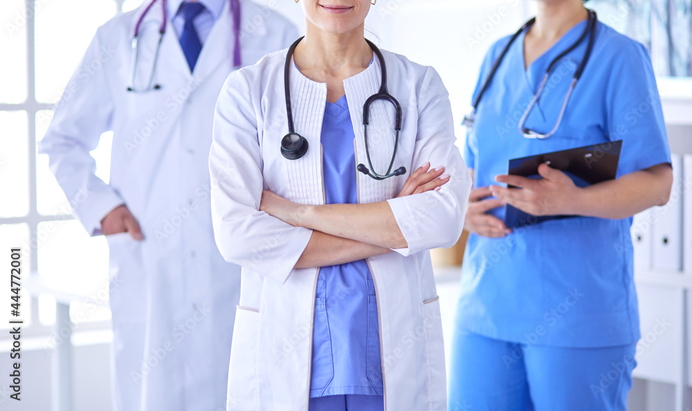 Group of doctors and nurses standing in the hospital room Group of doctors and nurses standing in the hospital room