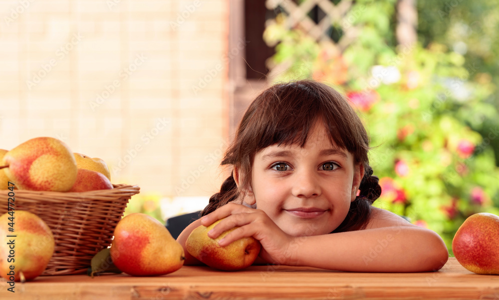 Fototapeta premium Cute little girl with pears.