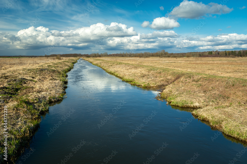 The calm Uherka River flows through the village of Czulczyce in eastern Poland The calm Uherka River flows through the village of Czulczyce in eastern Poland