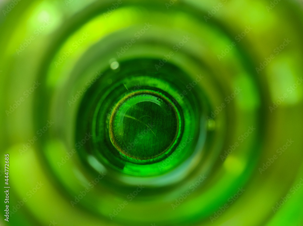 inside a greenglass bottle. Close-up view at the bottom of the bottle through the neck