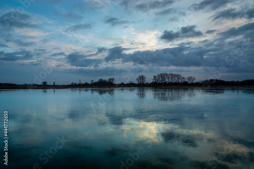 Reflection of evening clouds in a frozen lake