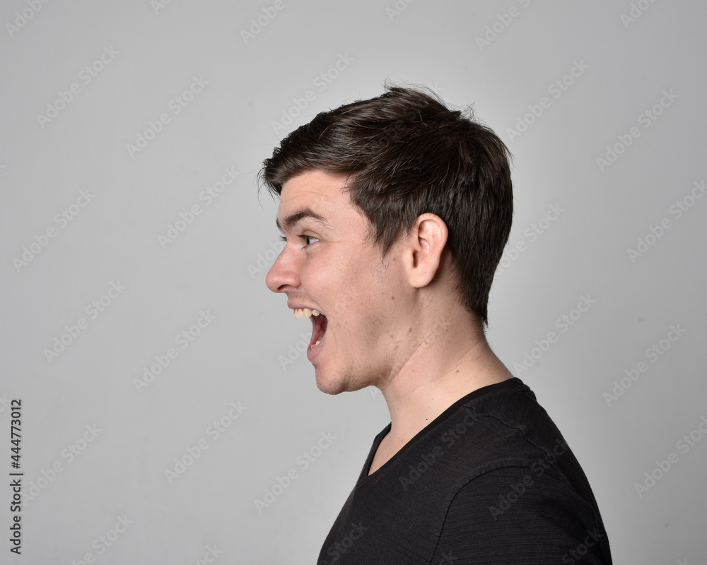 Close up head and shoulders portrait of a brunette. young man with a variety of expressive facial expressions. Isolated on a light grey studio background. Close up head and shoulders portrait of a brunette. young man with a variety of expressive facial expressions. Isolated on a light grey studio background.