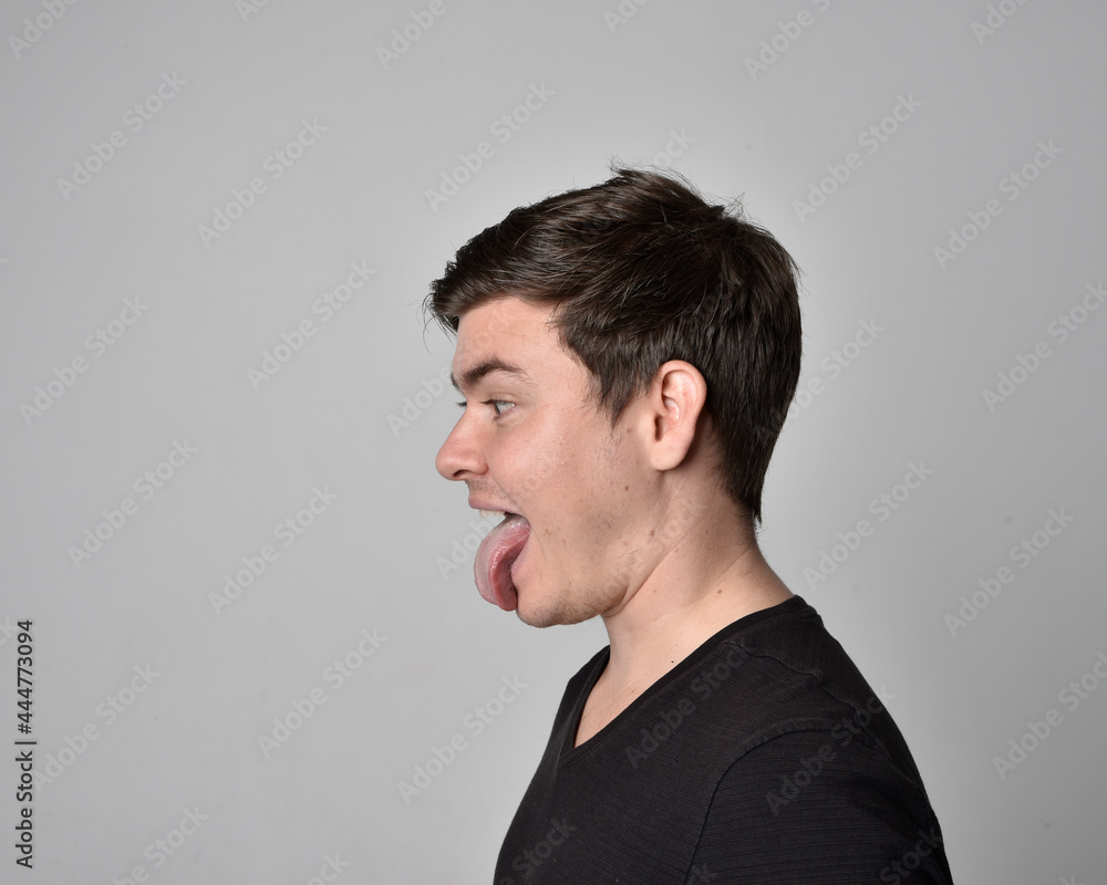 Close up head and shoulders portrait of a brunette. young man with a variety of expressive facial expressions. Isolated on a light grey studio background. Close up head and shoulders portrait of a brunette. young man with a variety of expressive facial expressions. Isolated on a light grey studio background.