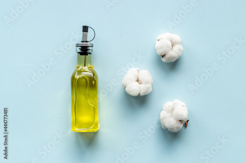 Cotton seeds oil with plant flowers. Essence extra virgin oil