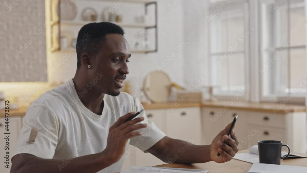 African man smiling and waving hand during video call African man smiling and waving hand during video call