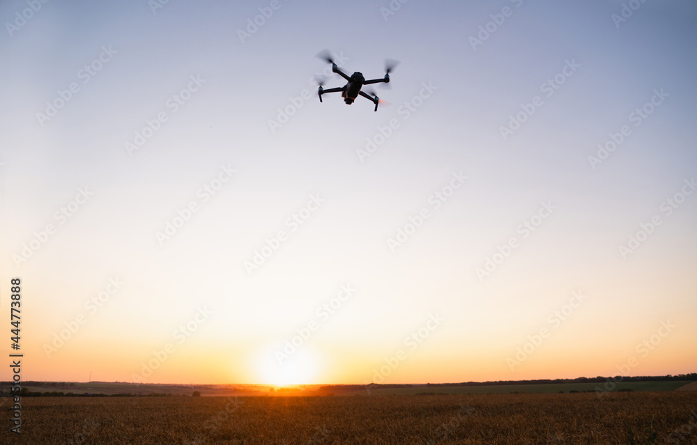 Drone flies over a wheat field. Smart farming and precision agriculture Drone flies over a wheat field. Smart farming and precision agriculture