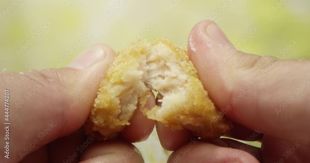 Two Hands Tearing Apart a Piece of Fried Chicken Nugget on the Table Dollying in to a Macro Shot with Green Background
Two Hands Tearing Apart a Piece of Fried Chicken Nugget on the Table Dollying in to a Macro Shot with Green Background