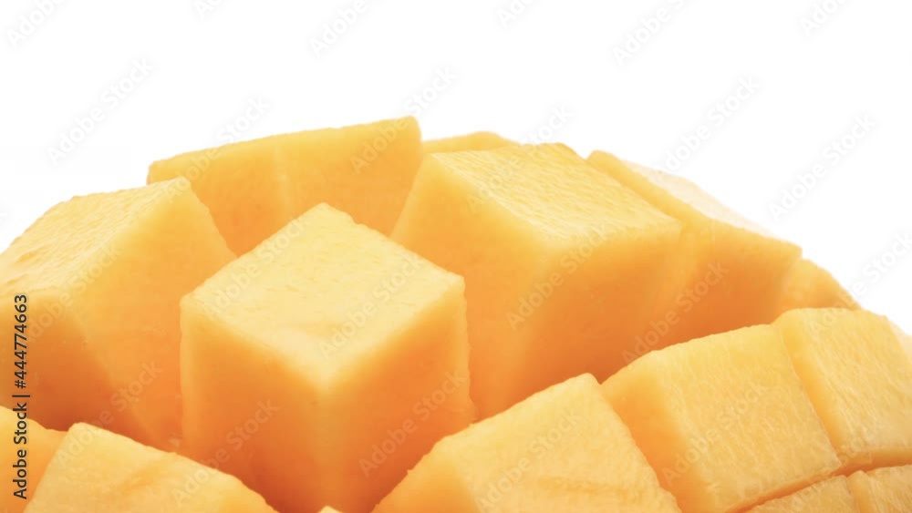 Macro shooting of hedgehog style prepared mango. Rotating. White background. Macro shooting of hedgehog style prepared mango. Rotating. White background.