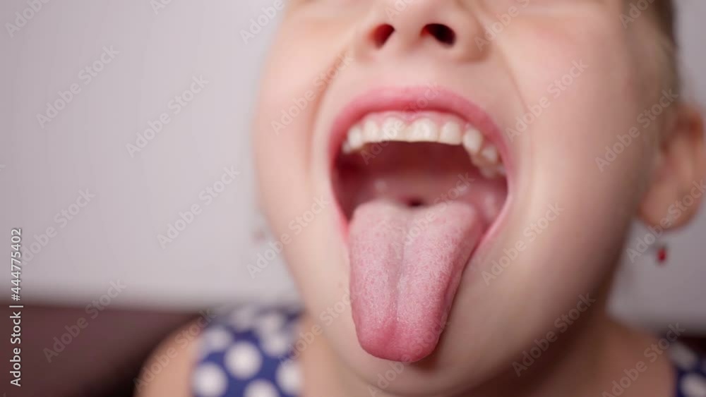 girl opens her mouth wide and pulls out long tongue. child ...   
