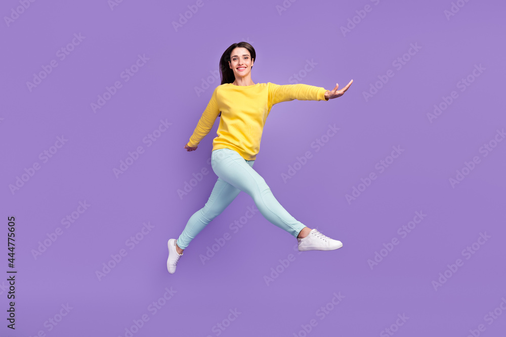 Full length body size view of attractive cheerful carefree girl jumping walking isolated over violet purple color background