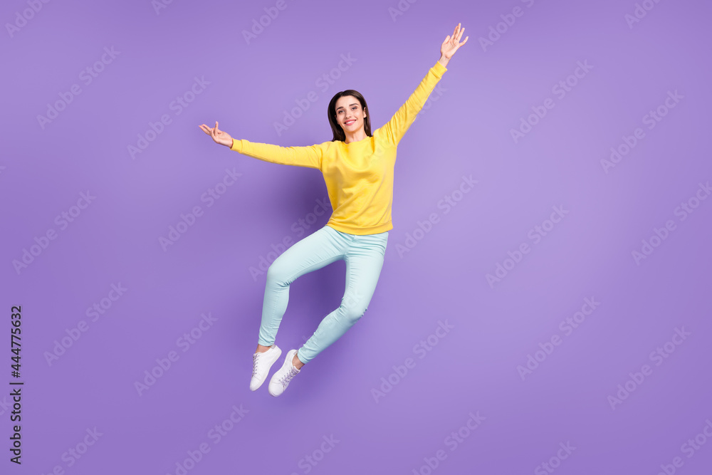 Full size photo of cheerful young happy woman jump up good mood smile isolated on purple violet color background