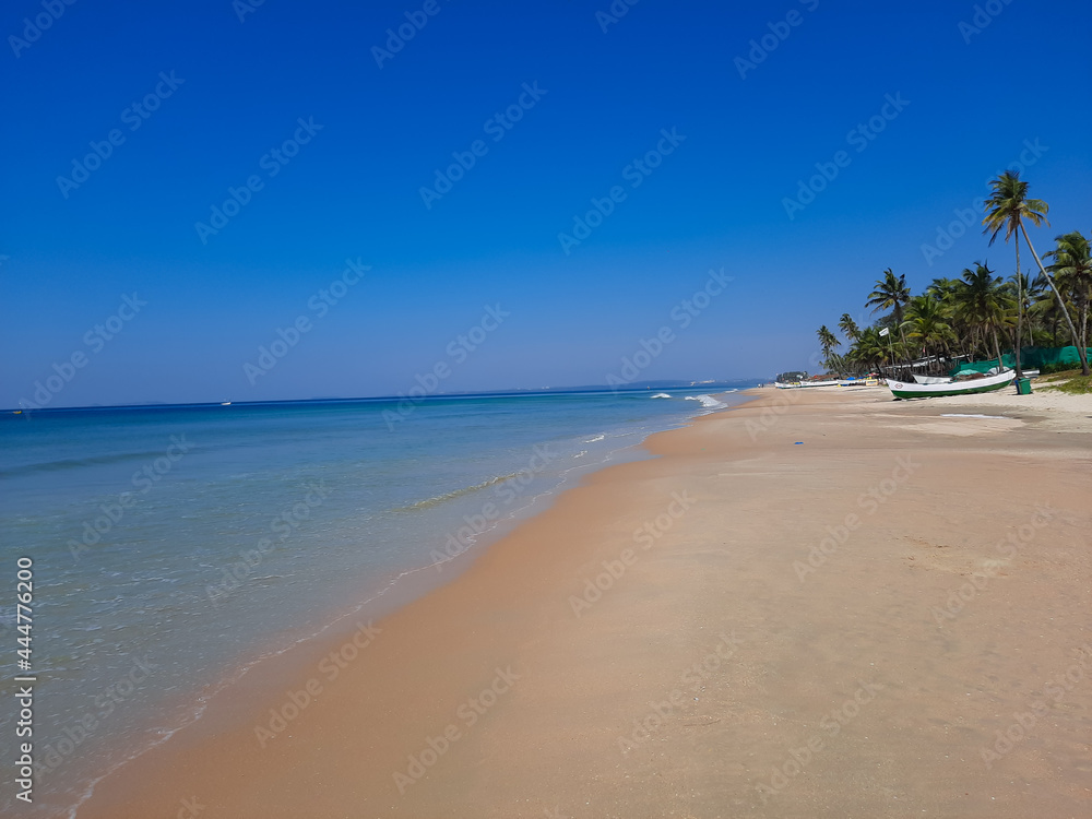 Blue water beach, tropical ocean beach, Summer vacation travel holiday background concept. Sea view tropical beach with sunny sky of Goa beach.
