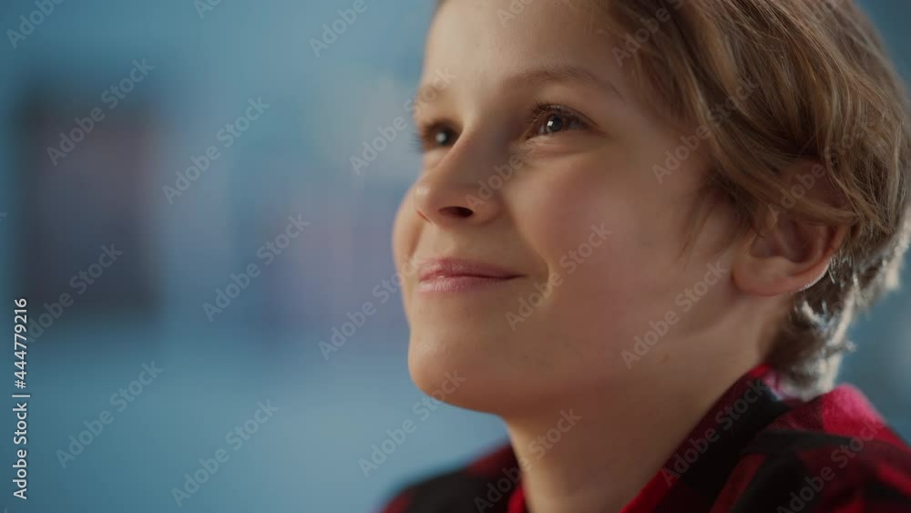 Portrait of a Bright Young Boy Being Concentrated, Looking into the Distance and Thinking About Something in Cozy Room at Home. Cute Teenager with Brown Eyes is Happy and Smiles. Portrait of a Bright Young Boy Being Concentrated, Looking into the Distance and Thinking About Something in Cozy Room at Home. Cute Teenager with Brown Eyes is Happy and Smiles.
