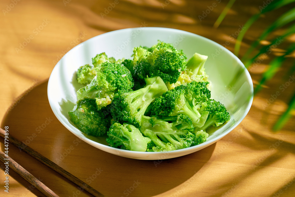 Stewed broccoli in garlic sauce in a white plate. Chinese recipe and cuisine Stewed broccoli in garlic sauce in a white plate. Chinese recipe and cuisine