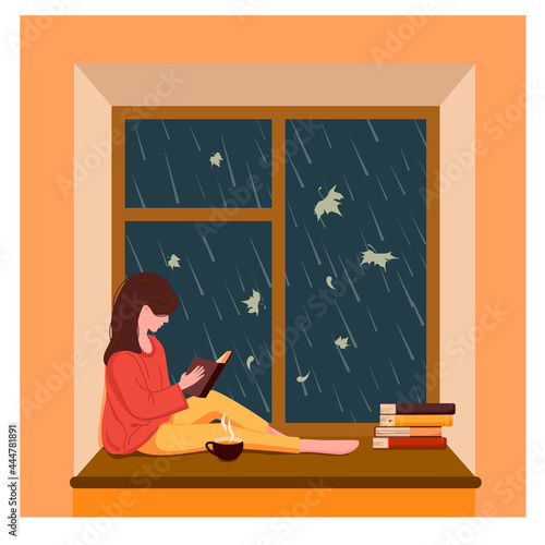 A girl sits by the window, reads a book and drinks tea while it is raining outside the window. Vector illustration