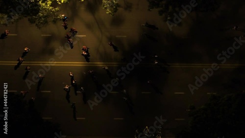 Aerial shot of many runners running on the street at night of Ho Chi Minh City, Vietnam photo