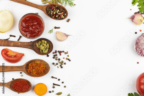  Fresh vegetables and spices, spices in wooden spoons, isolated on white background with space for text.