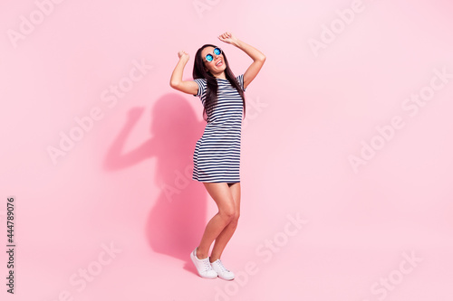 Full length body size view of lovely cheerful woman dancing having fun summertime isolated over pink pastel color background