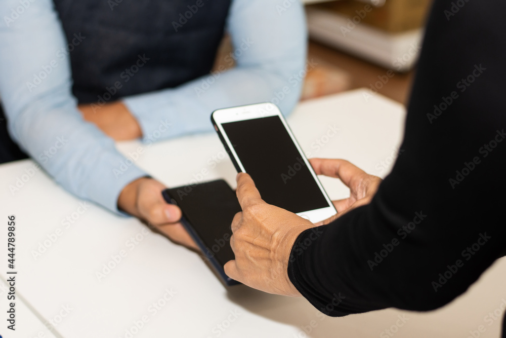 People using smartphone mobile banking scan QR code to pay in shop