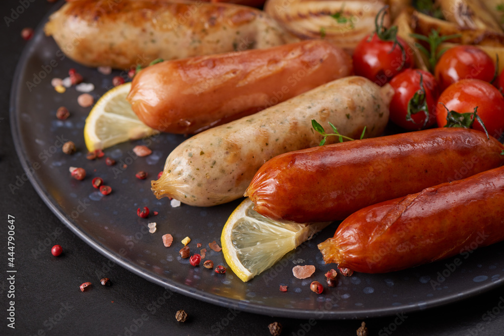 sausages and ingredients for cooking. Grilled sausage with the addition of herbs and and spices, vegetables, rosemary, thyme on the grill plate, Grilling food, bbq, barbecue, on stone table. Top view. sausages and ingredients for cooking. Grilled sausage with the addition of herbs and and spices, vegetables, rosemary, thyme on the grill plate, Grilling food, bbq, barbecue, on stone table. Top view.