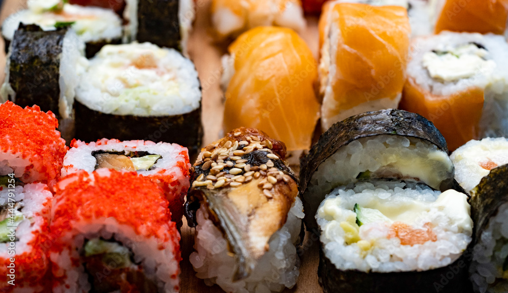 Closeup view on colorful set with sushi, maki and sashimi with raw salmon. Closeup view on colorful set with sushi, maki and sashimi with raw salmon.