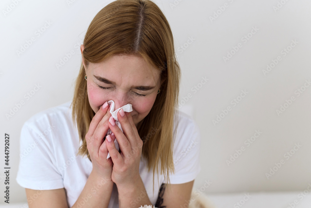 Sick millennial woman feeling bad, weak fight against flu, runny nose, rest at home, health problem concept. The woman blows her nose into a handkerchief. depression, sadness and crying Sick millennial woman feeling bad, weak fight against flu, runny nose, rest at home, health problem concept. The woman blows her nose into a handkerchief. depression, sadness and crying