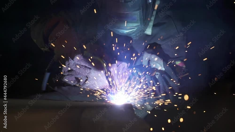 Person is welding metal object in construction site. Slow motion tight shot. High quality FullHD footage Person is welding metal object in construction site. Slow motion tight shot. High quality FullHD footage