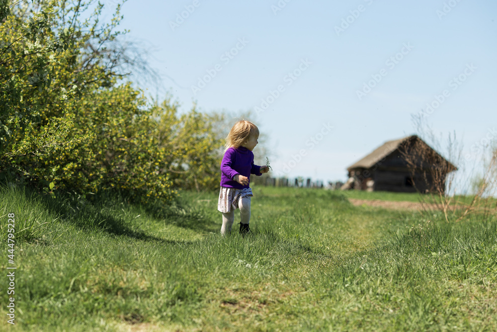 a girl in a dress runs and looks back at the house behind her a girl in a dress runs and looks back at the house behind her