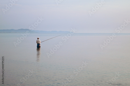 Rybak łowiący ryby w morzu © Dominika