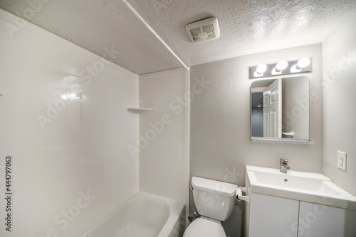 Small all white bathroom interior with vanity sink and mirror