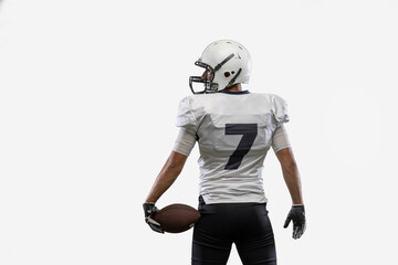 Close-up American football player with ball isolated on white studio background. Back view