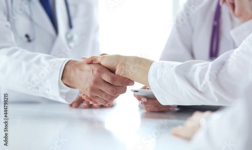 Doctor shaking hands with a male patient in the office © lenets_tan