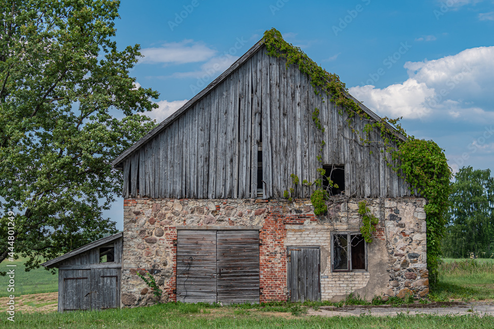 An old abandoned house from bricks, wooden planks and stones. An old abandoned house from bricks, wooden planks and stones.