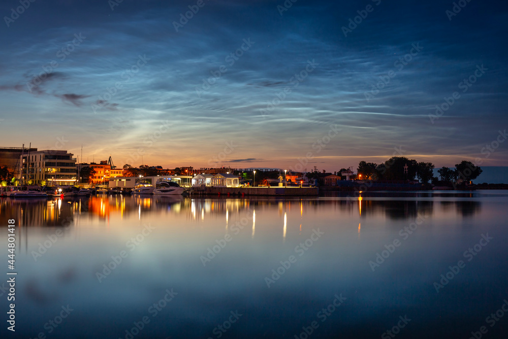 Night scenery in Gdynia with noctilucent clouds over the harbor. Poland