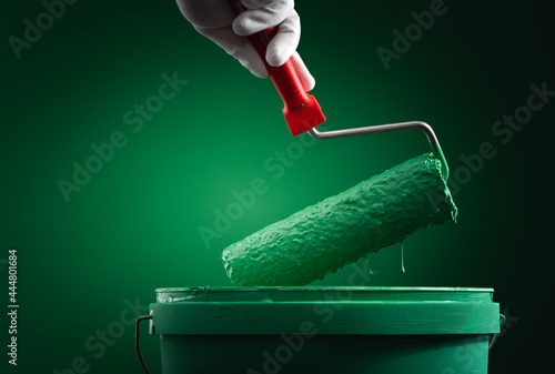  paint roller on a bucket with paint photo
