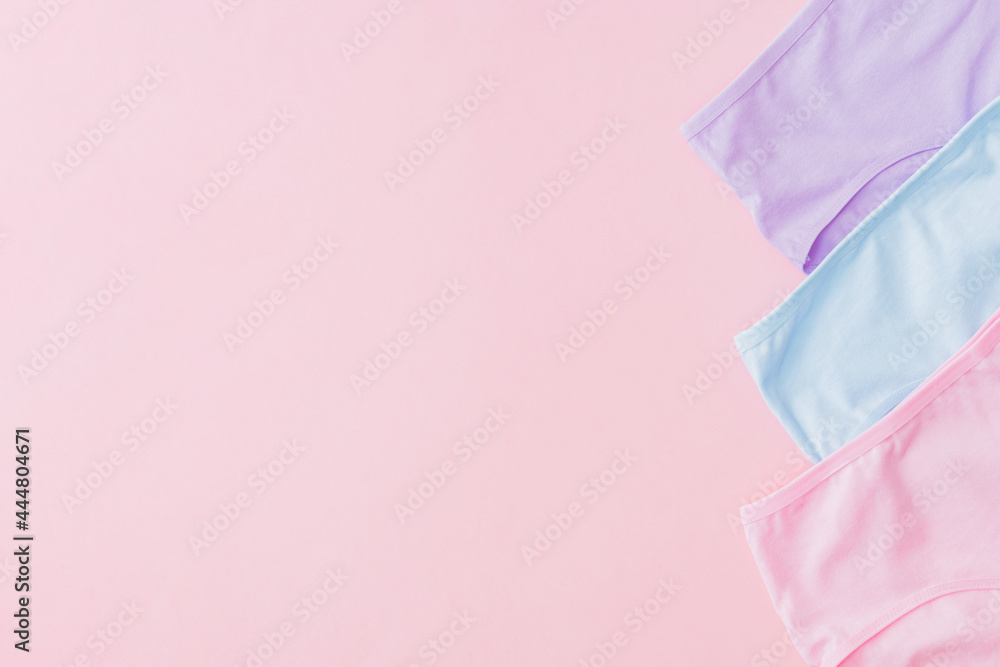 Flat lay set of women panties of different colors on a pink background. Top view advertising and shopping concept Flat lay set of women panties of different colors on a pink background. Top view advertising and shopping concept